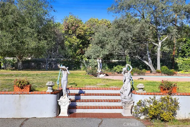 a view of a swimming pool and a back yard