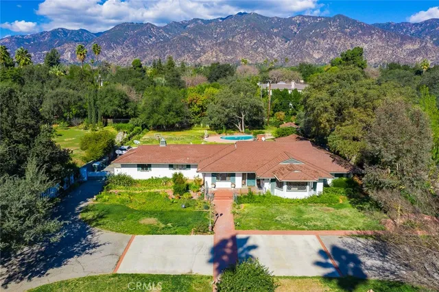 an aerial view of a house with garden space and street view