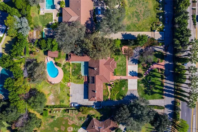 an aerial view of residential house with outdoor space and swimming pool