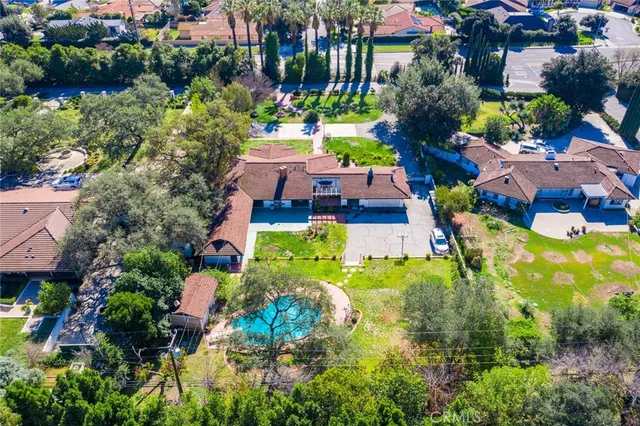 an aerial view of residential house with swimming pool and outdoor space