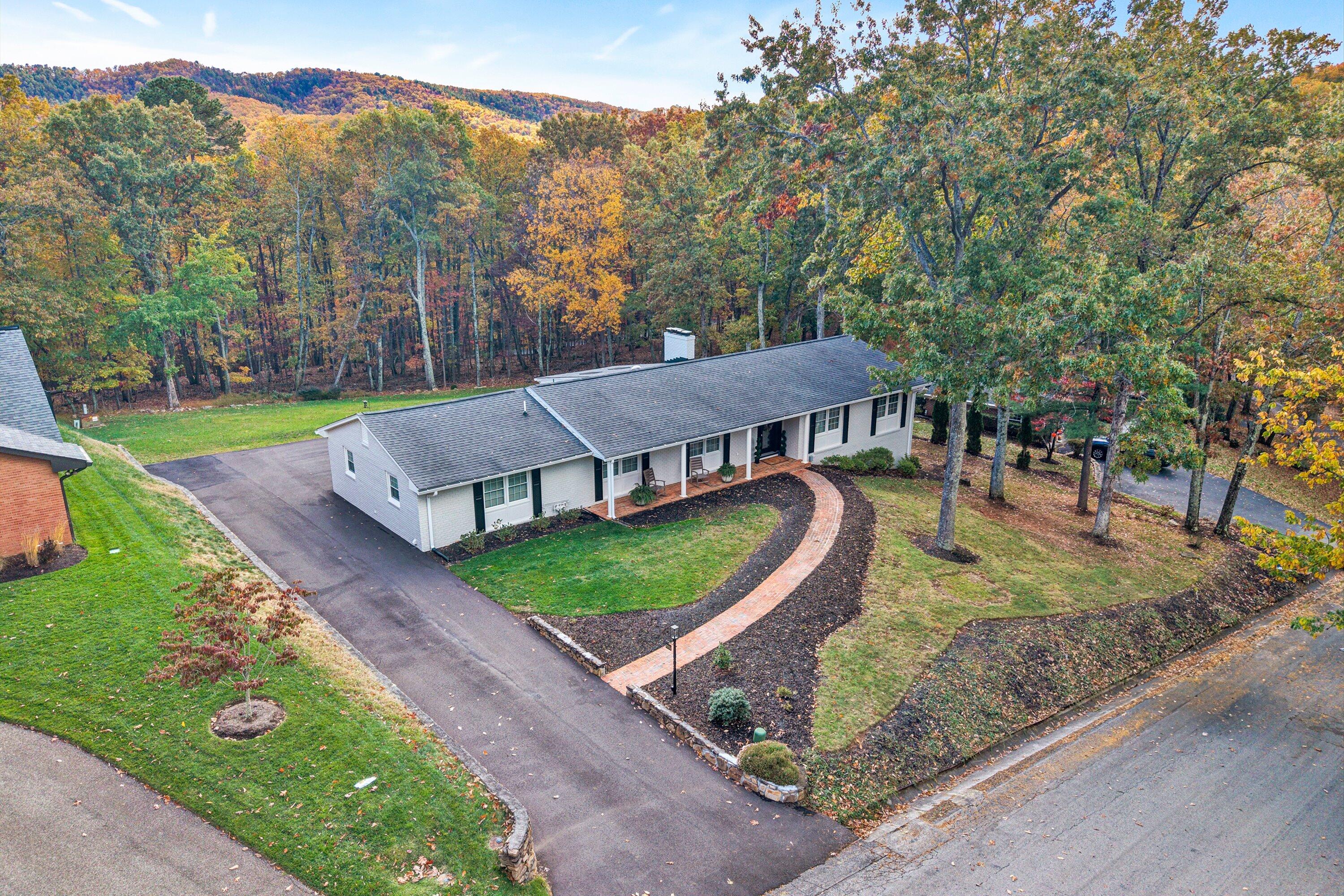 5063 Falcon Ridge Road Roanoke, VA 24018 - Photo 3 of 82 an aerial view of a house with garden space and trees