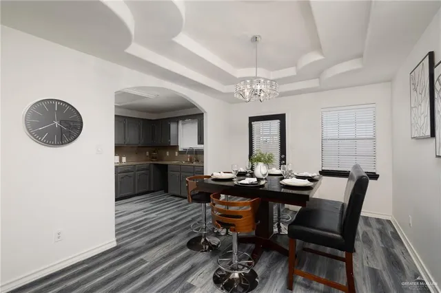 a view of a dining room with furniture and chandelier