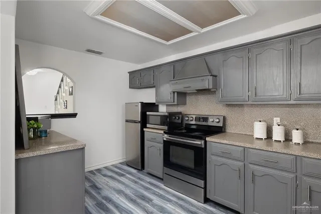 a kitchen with stainless steel appliances granite countertop a stove and a refrigerator