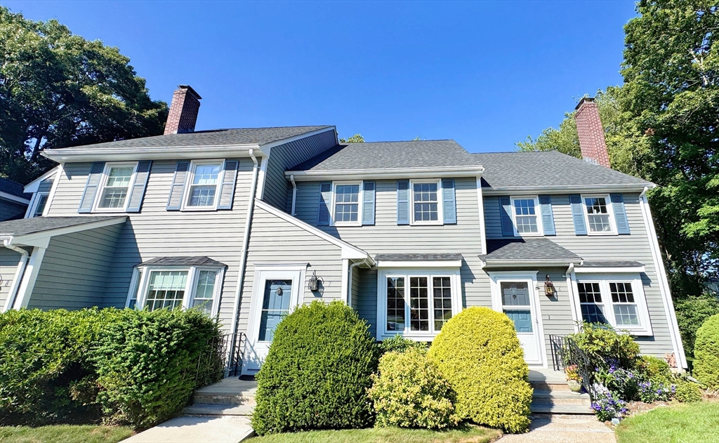 7 Washington Green, Unit 7 Walpole, MA 02032 - Photo 1 of 23 a front view of a house with a yard