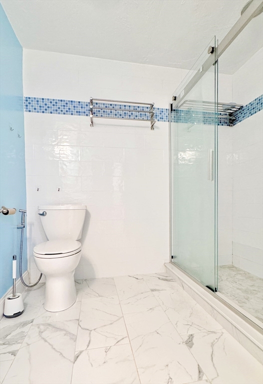 7 Washington Green, Unit 7 Walpole, MA 02032 - Photo 11 of 23 a bathroom with a toilet and a shower