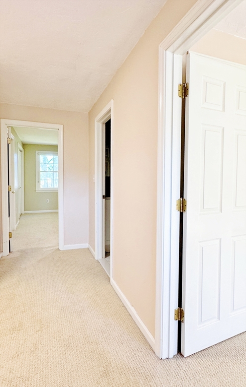 7 Washington Green, Unit 7 Walpole, MA 02032 - Photo 12 of 23 a view of a hallway with wooden floor and closet