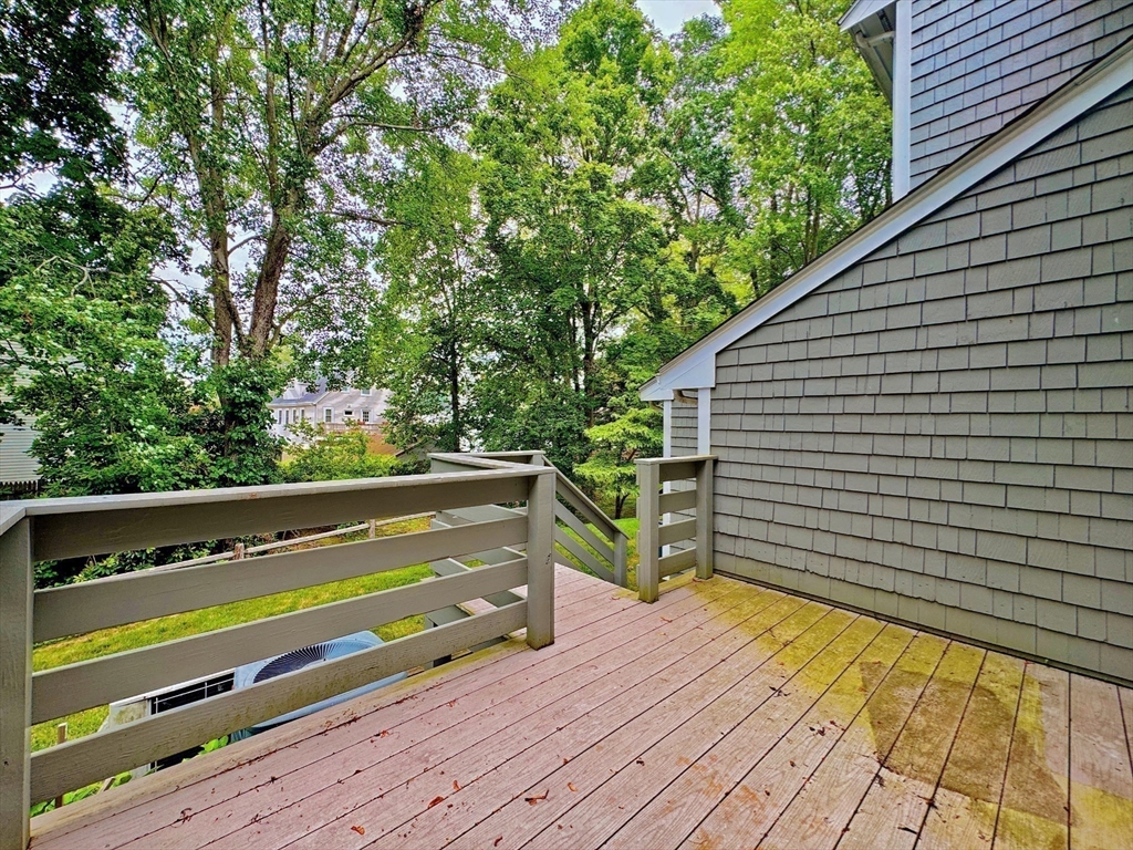7 Washington Green, Unit 7 Walpole, MA 02032 - Photo 19 of 23 a view of a wooden deck with a bench