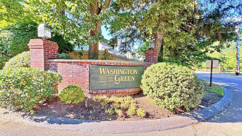 7 Washington Green, Unit 7 Walpole, MA 02032 - Photo 23 of 23 a sign that is next to a road