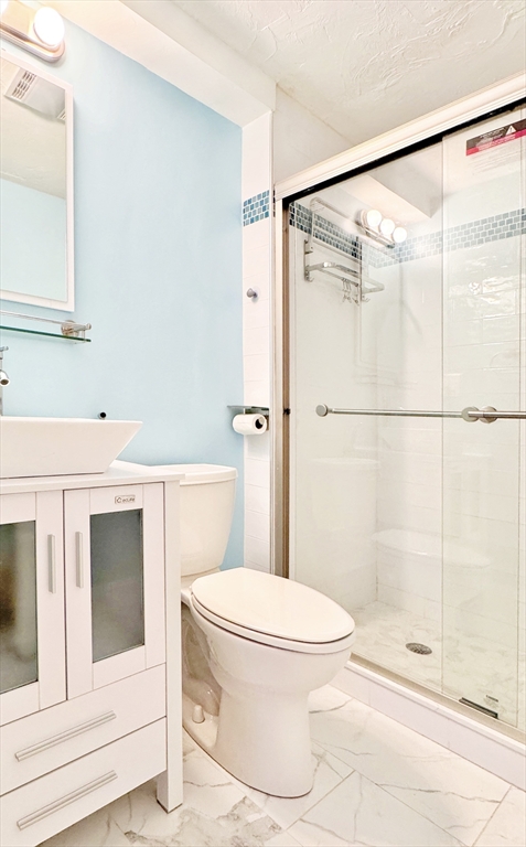 7 Washington Green, Unit 7 Walpole, MA 02032 - Photo 7 of 23 a bathroom with a toilet and a shower