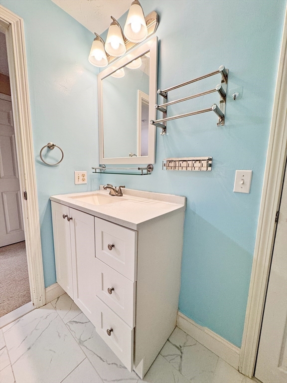 7 Washington Green, Unit 7 Walpole, MA 02032 - Photo 10 of 23 a bathroom with a sink a mirror and a shower