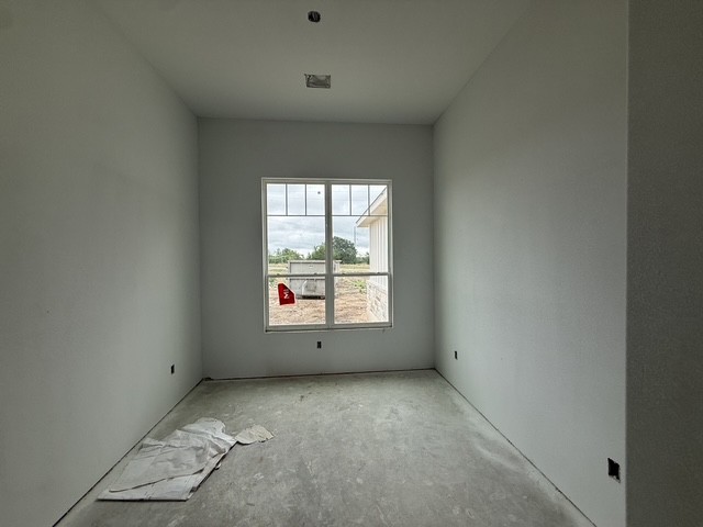 127 Riparian Elms Road Bertram, TX 78605 - Photo 7 of 22 A window-filled room with clean lines, awaiting a personalized design.