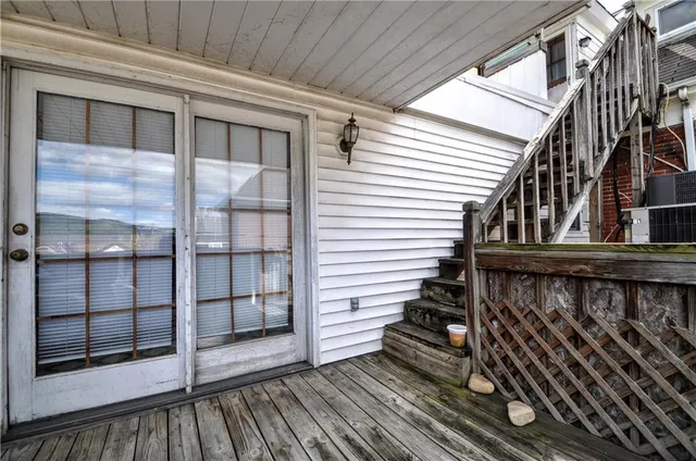 a bathroom with a granite countertop sink and a shower