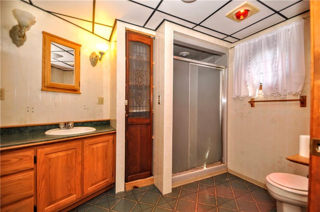 509 West Main Street Monongahela, PA 15063 - Photo 20 of 39 a bathroom with a granite countertop sink and a shower