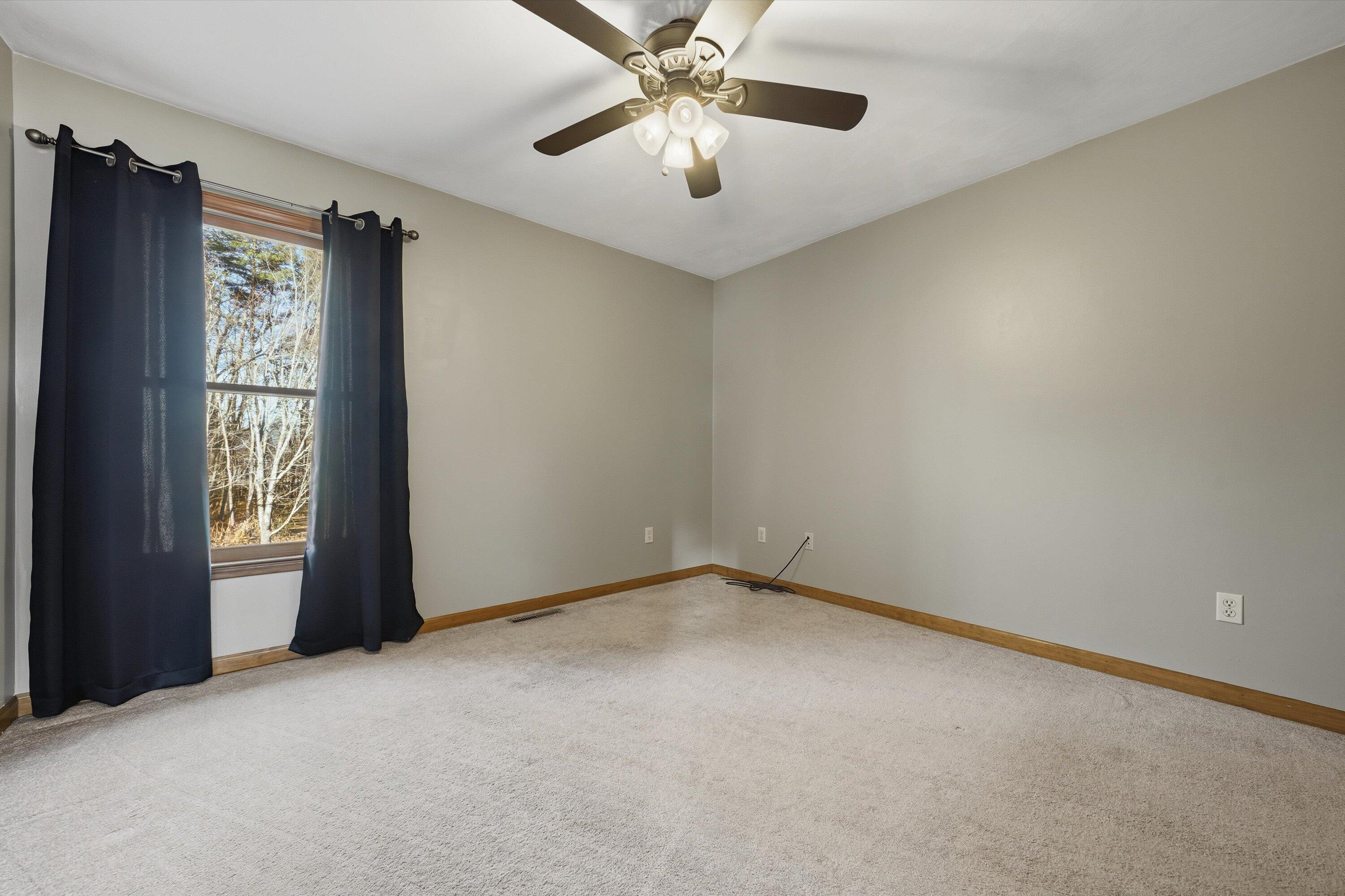460 Stonybrook Road Wirtz, VA 24184 - Photo 22 of 44 an empty room with windows and fan