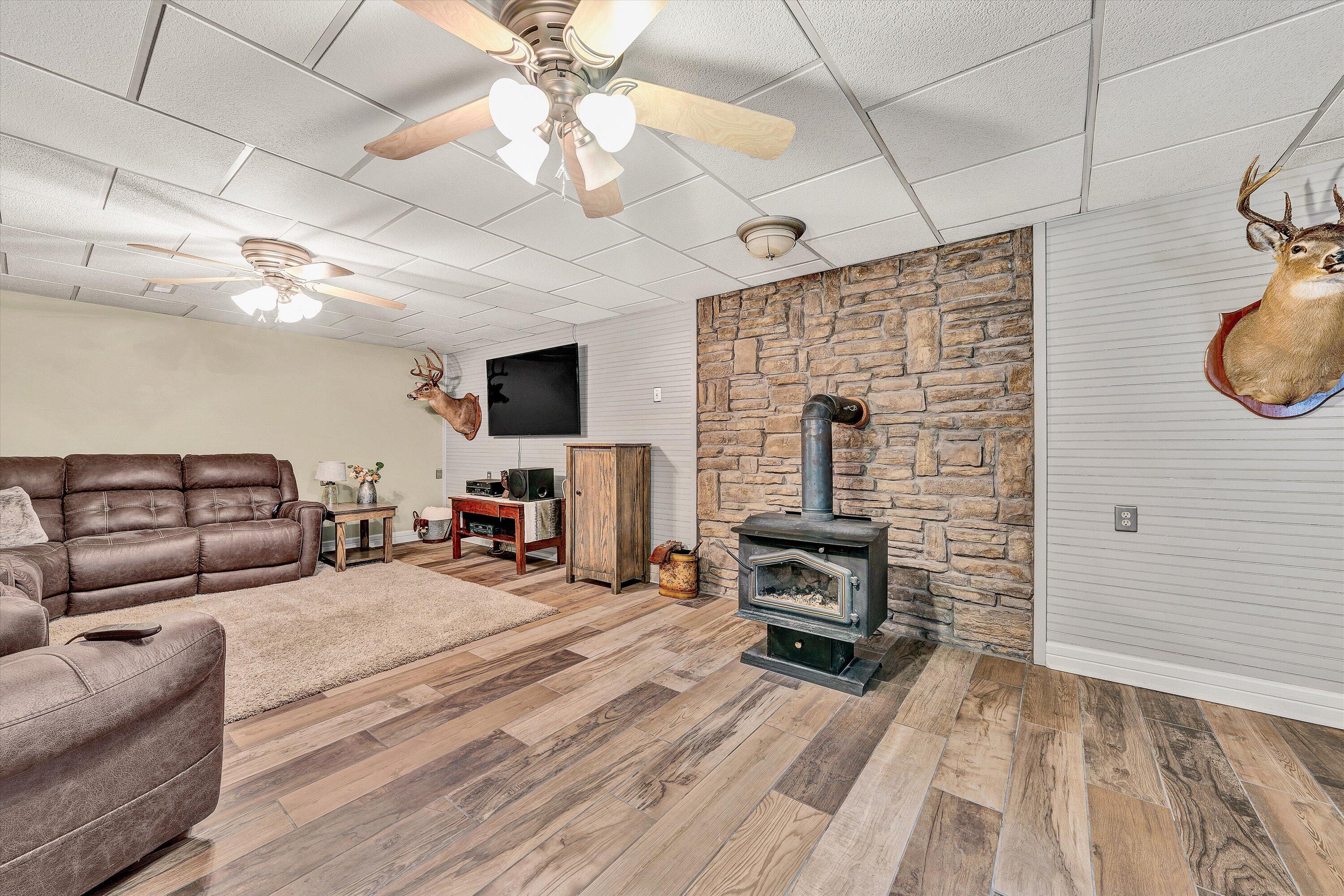 460 Stonybrook Road Wirtz, VA 24184 - Photo 27 of 44 a living room with furniture a flat screen tv and a fireplace