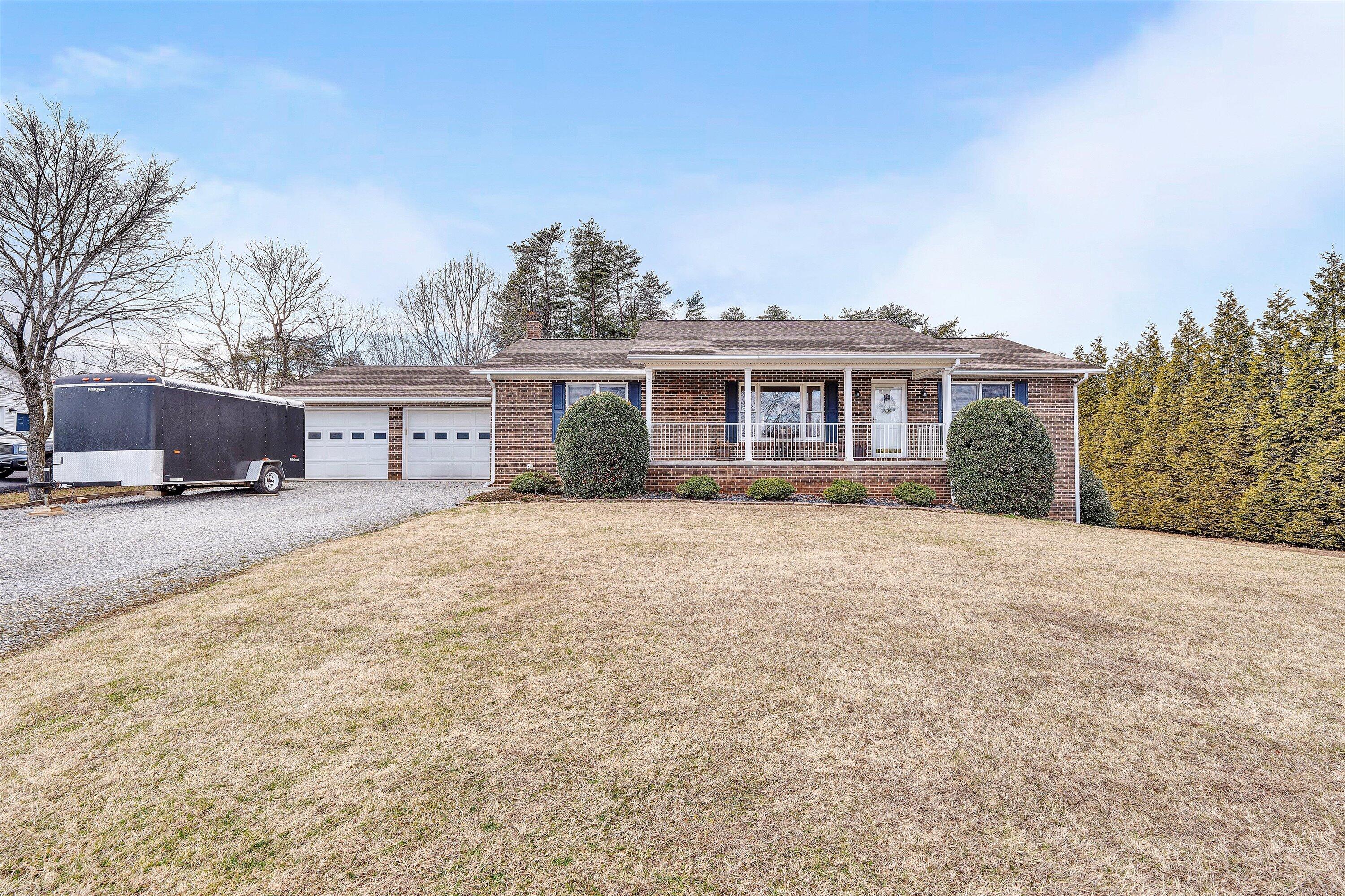 460 Stonybrook Road Wirtz, VA 24184 - Photo 3 of 44 a front view of a house with a yard and potted plants