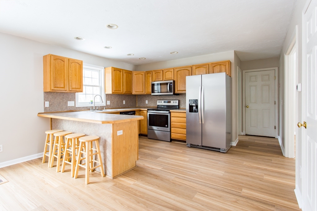 270 New Braintree Road West Brookfield, MA 01585 - Photo 8 of 37 a kitchen with stainless steel appliances granite countertop a refrigerator a stove a sink and a microwave