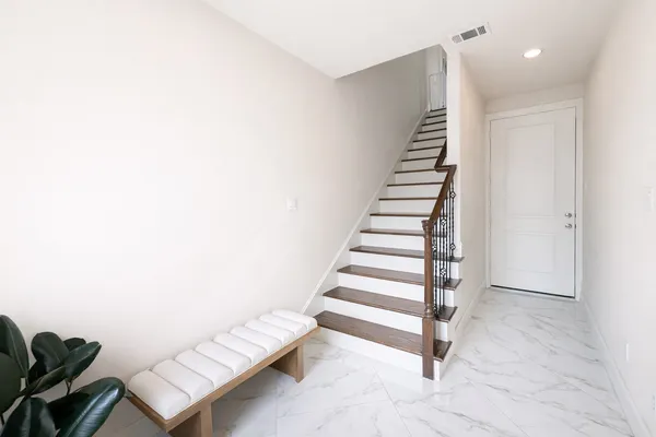 a view of an empty room with stairs