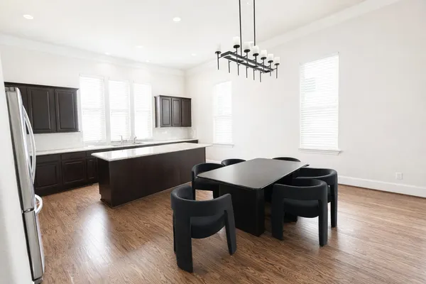 a kitchen with granite countertop a refrigerator a sink dishwasher a stove top oven a refrigerator and cabinets