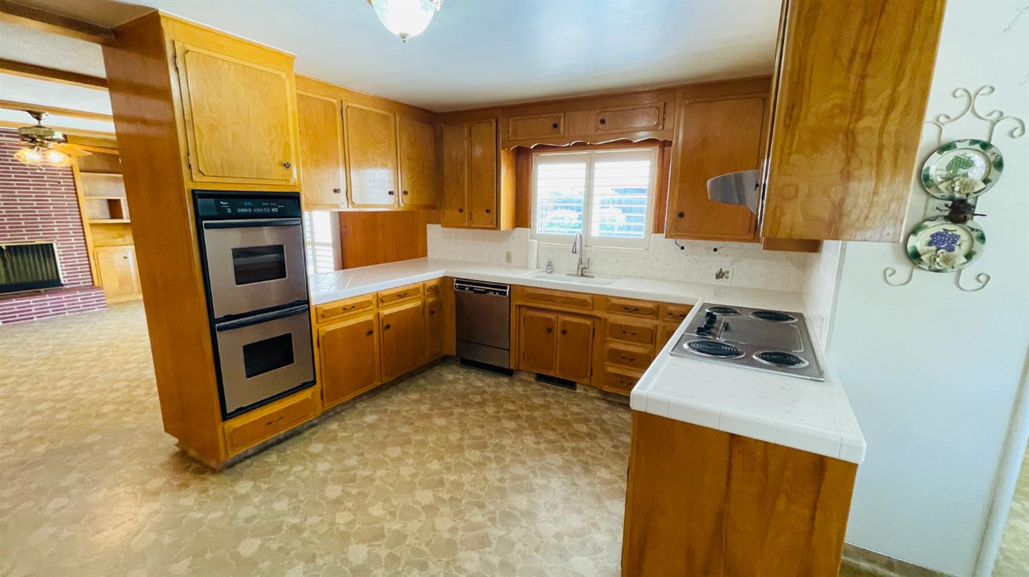 712 Leytonstone Avenue Modesto, CA 95355 - Photo 15 of 32 Larger open kitchen with solid wood cabinets and new stainless appliances including double ovens and fridge.