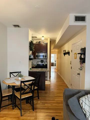a living room with furniture and a kitchen view