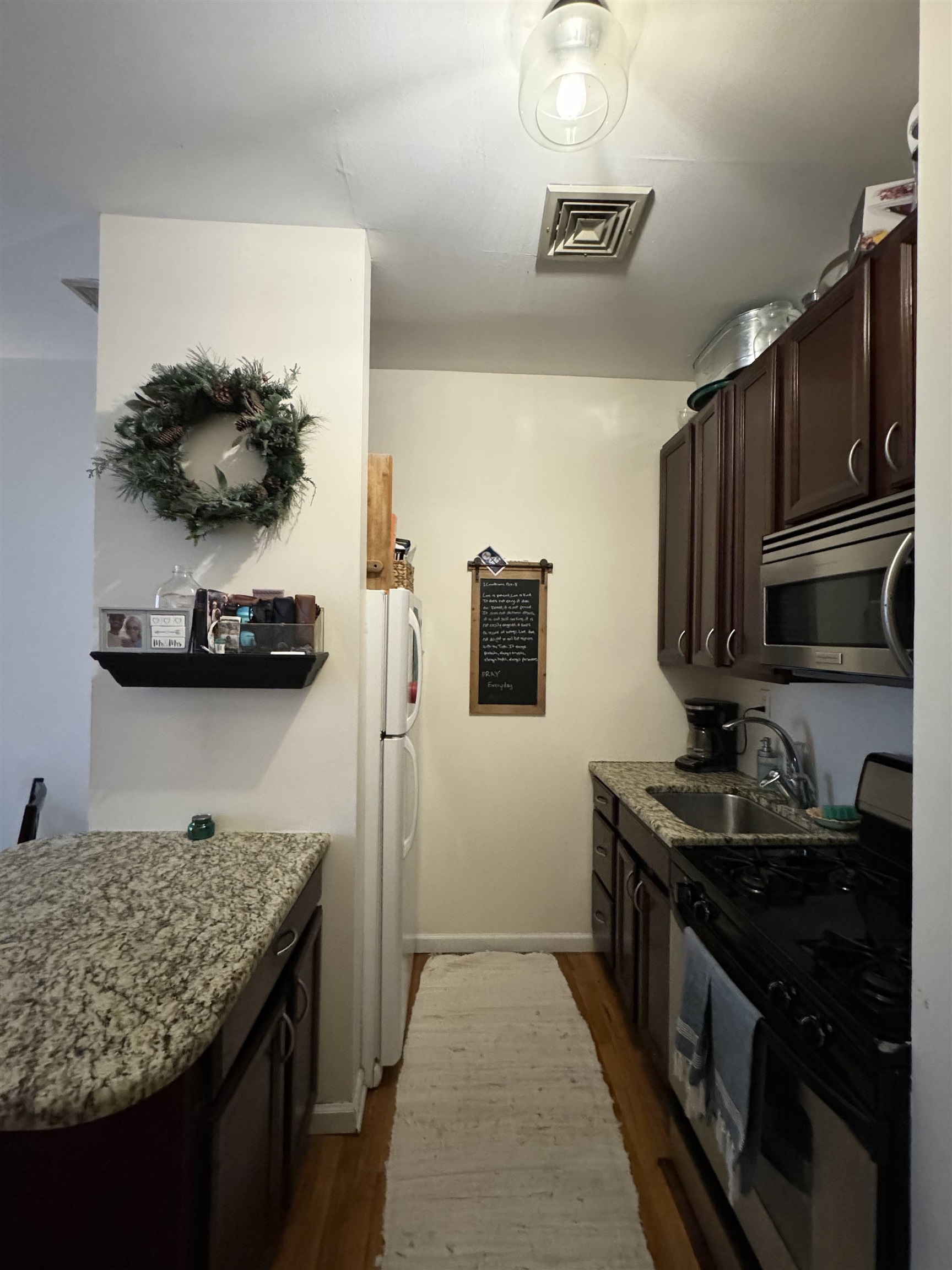 155 14th Street, Unit 2L Hoboken, NJ 07030 - Photo 5 of 13 a kitchen with a sink and a stove