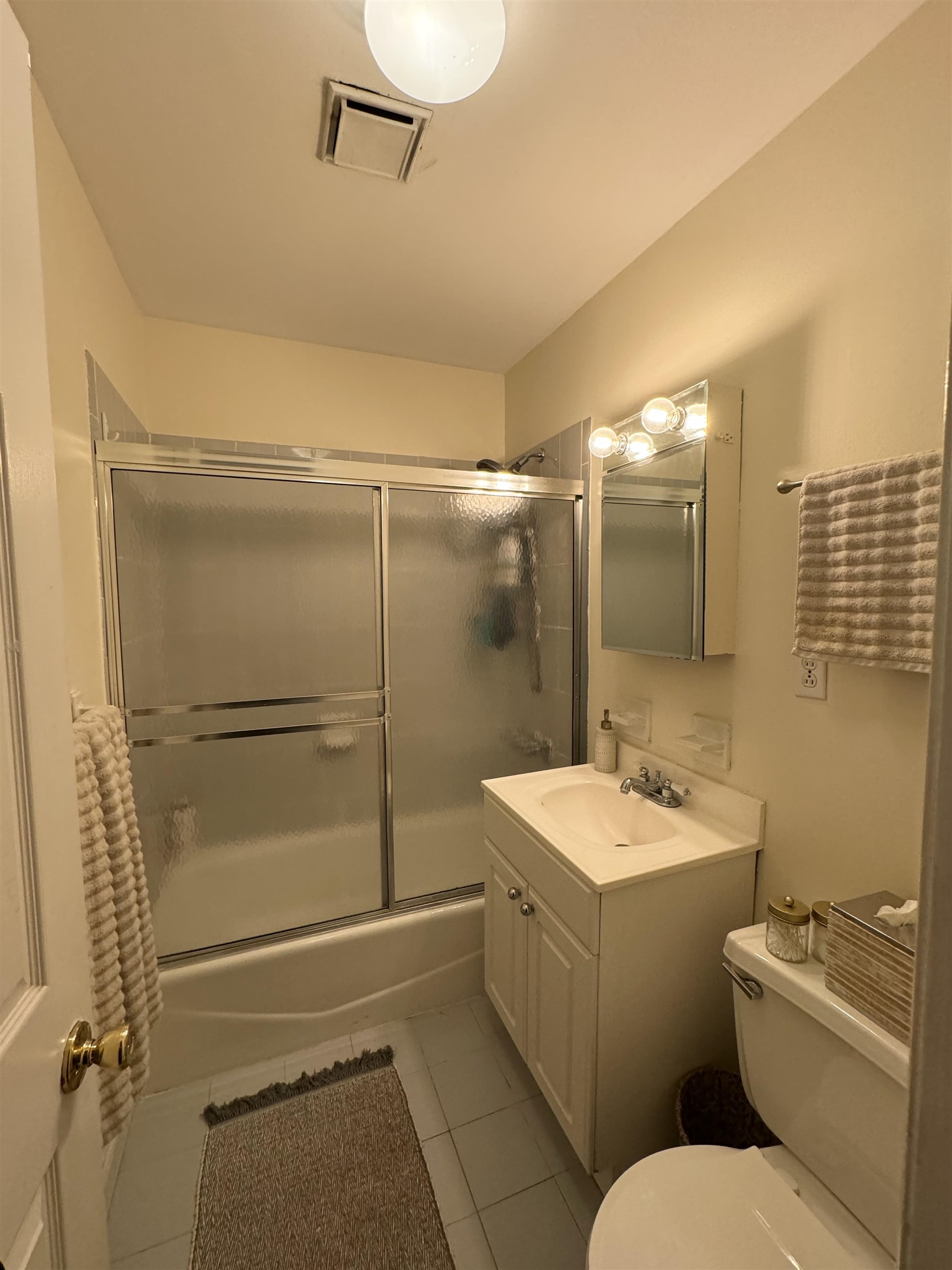 155 14th Street, Unit 2L Hoboken, NJ 07030 - Photo 8 of 13 a bathroom with a granite countertop sink toilet a mirror and shower