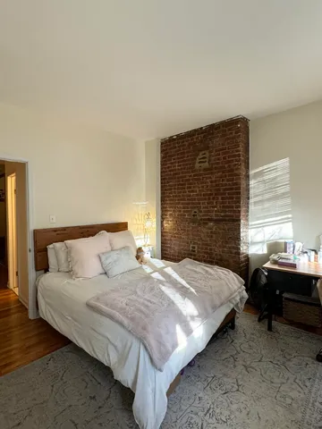 a bedroom with a bed and window