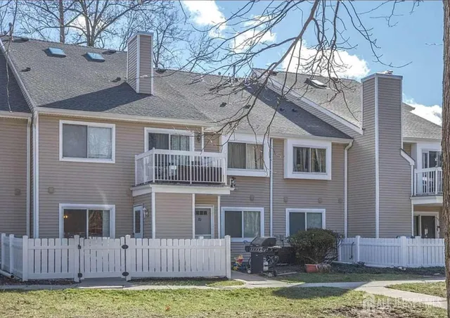 a front view of a house with yard and garage