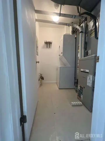 a view of a room with water heater and stairs