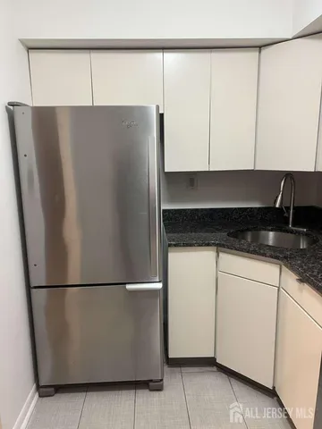 a kitchen with a refrigerator and cabinets