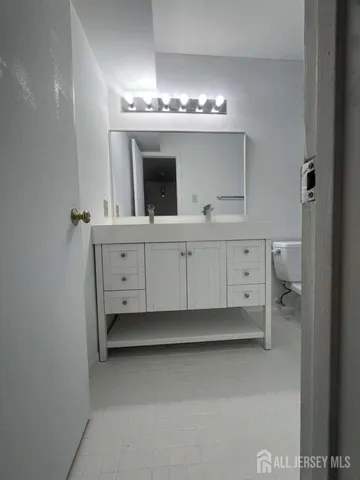 a view of spacious bedroom with a chandelier