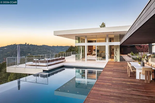 a view of a patio with dining table and chairs with wooden floor and fence