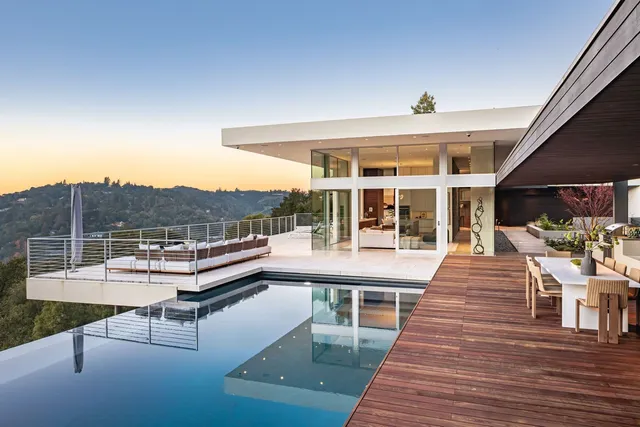 a view of a patio with dining table and chairs with wooden floor and fence