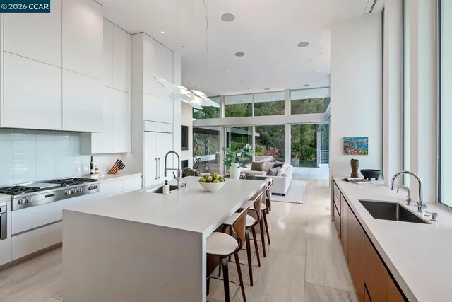 a dining room with furniture and large windows