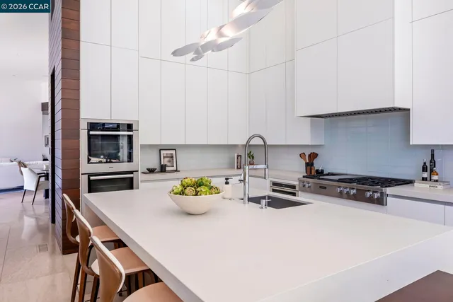 a kitchen with a stove and a white cabinets