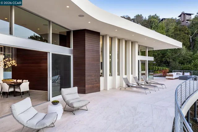 a view of the patio with couches chairs and potted plants