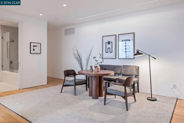 a spacious bedroom with a large bed and a potted plant