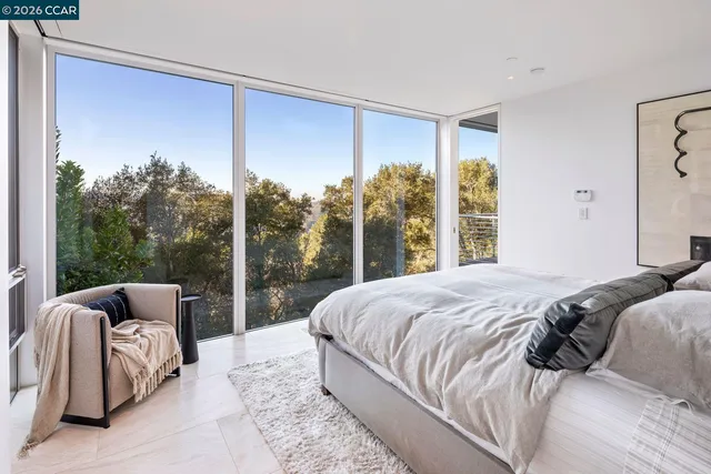a living room with furniture and a large window with outer view