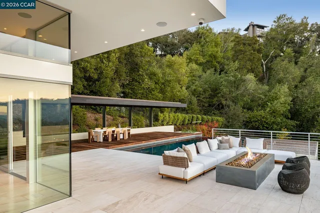 a view of a house with a yard and a large parking space