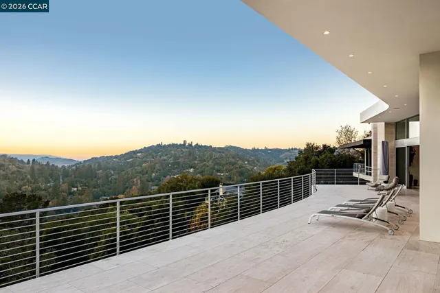 an aerial view of residential houses with outdoor space and trees