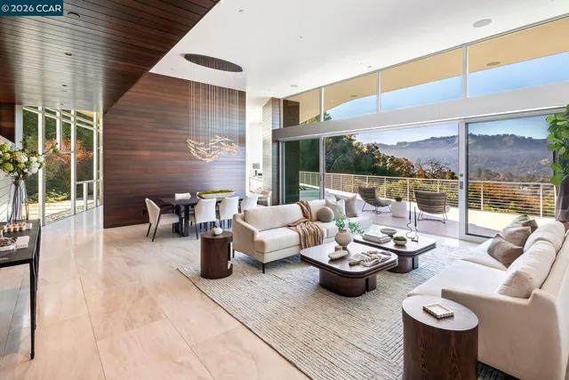 a view of a dining room with furniture a chandelier and wooden floor