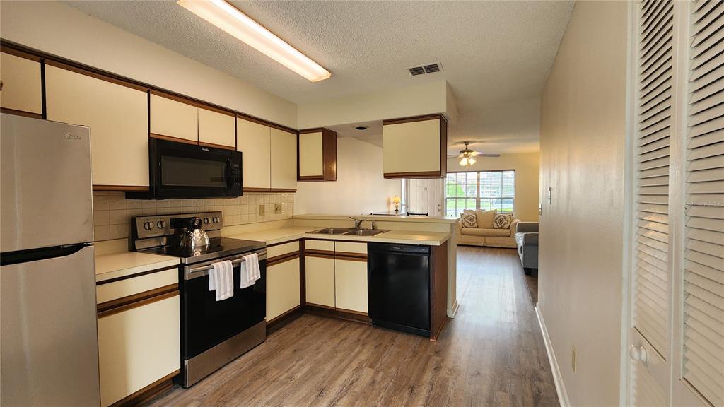 6440 Spring Flower Drive, Unit 14 New Port Richey, FL 34653 - Photo 12 of 35 a kitchen with stainless steel appliances and view of living room