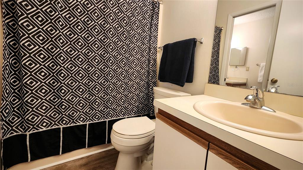 6440 Spring Flower Drive, Unit 14 New Port Richey, FL 34653 - Photo 17 of 35 a bathroom with a sink toilet and shower