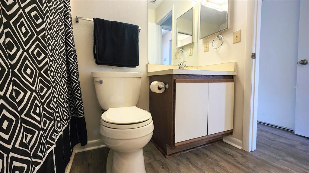 6440 Spring Flower Drive, Unit 14 New Port Richey, FL 34653 - Photo 18 of 35 a white toilet sitting next to a bathroom sink