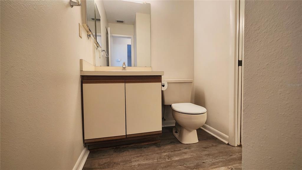 6440 Spring Flower Drive, Unit 14 New Port Richey, FL 34653 - Photo 19 of 35 a bathroom with a toilet sink and mirror