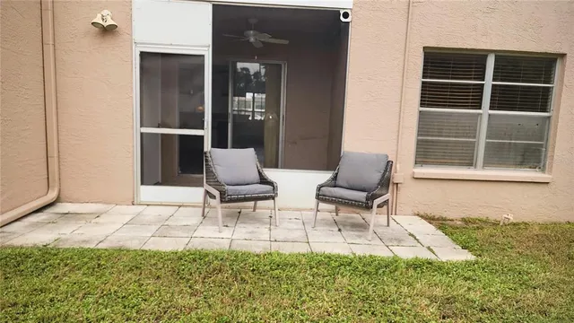 a balcony with chairs and a gate
