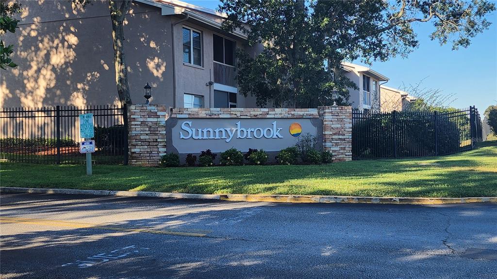 6440 Spring Flower Drive, Unit 14 New Port Richey, FL 34653 - Photo 2 of 35 a sign on the side of the building