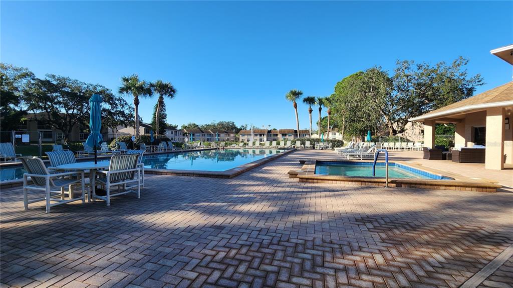 6440 Spring Flower Drive, Unit 14 New Port Richey, FL 34653 - Photo 22 of 35 a view of a patio with swimming pool table and chairs