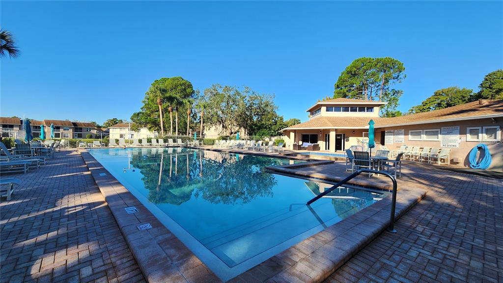 6440 Spring Flower Drive, Unit 14 New Port Richey, FL 34653 - Photo 24 of 35 a view of a house with pool and sitting area